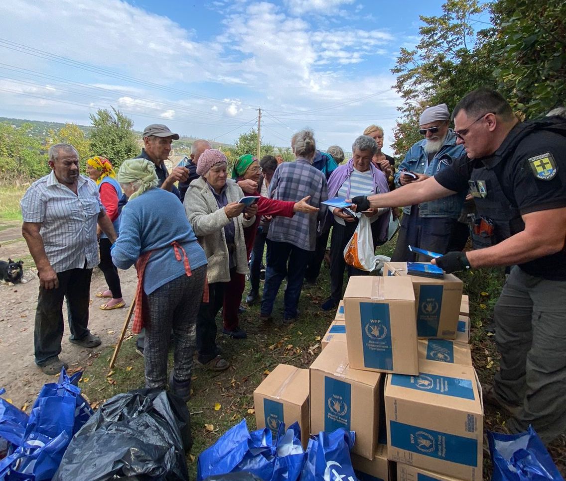 Distribution of the book “The Road Home” to frontline villagers. Gennady Mohnenko handing out the GCMM book.